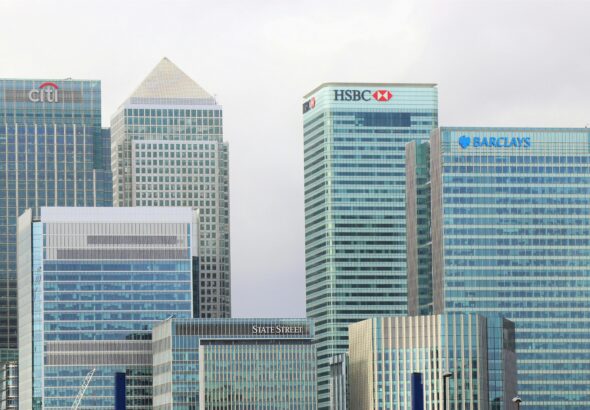 Modern skyline of Canary Wharf featuring iconic bank skyscrapers like HSBC and Barclays.