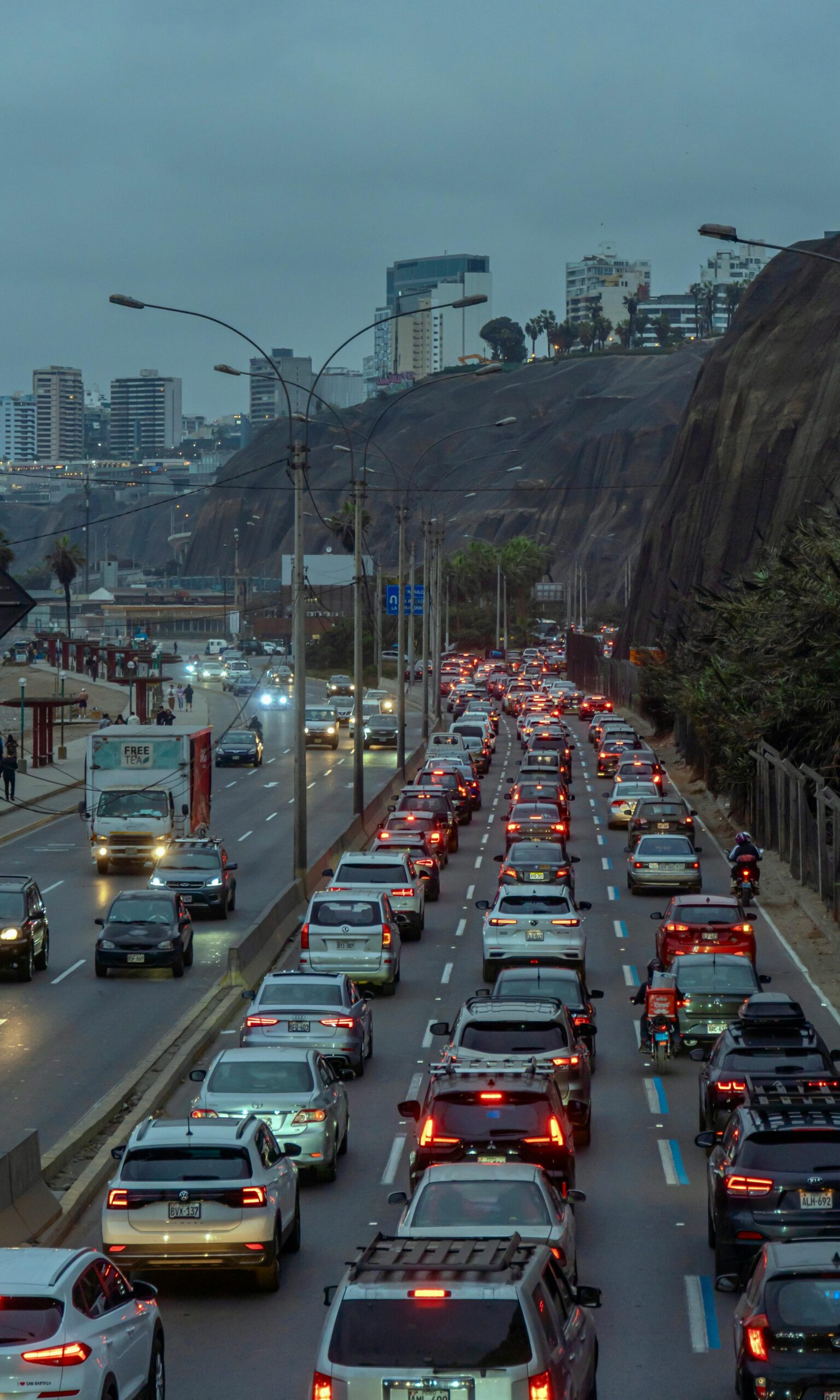 Heavy traffic during rush hour in Barranco, Lima, Peru under a cloudy sky.